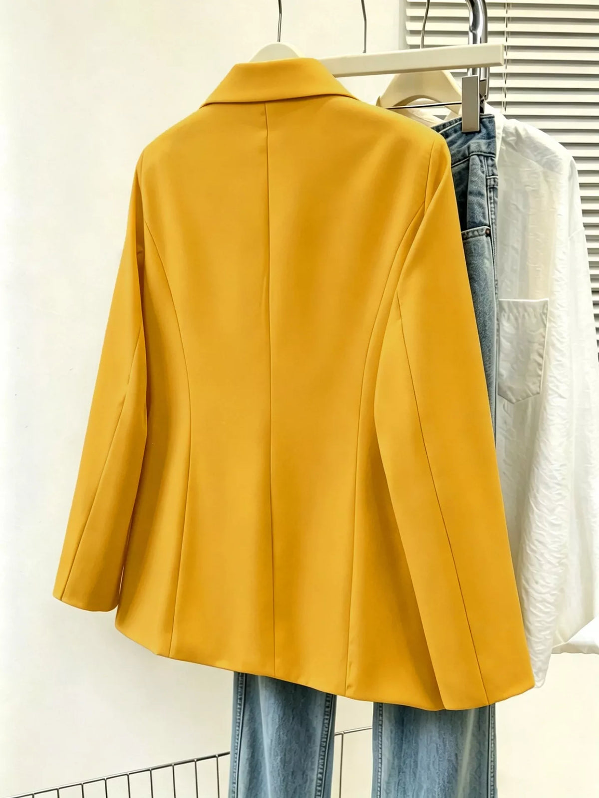 Plus size casual blazer with single-breasted design and lapel collar, featuring a trendy fit from Trendsi.