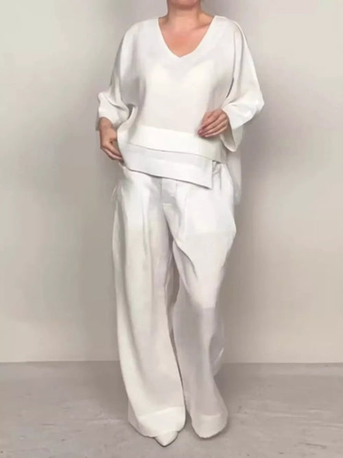 Plus size Trendsi V-neck long sleeve top and pants set, featuring comfortable pants with a relaxed fit, shown in a full-length view.