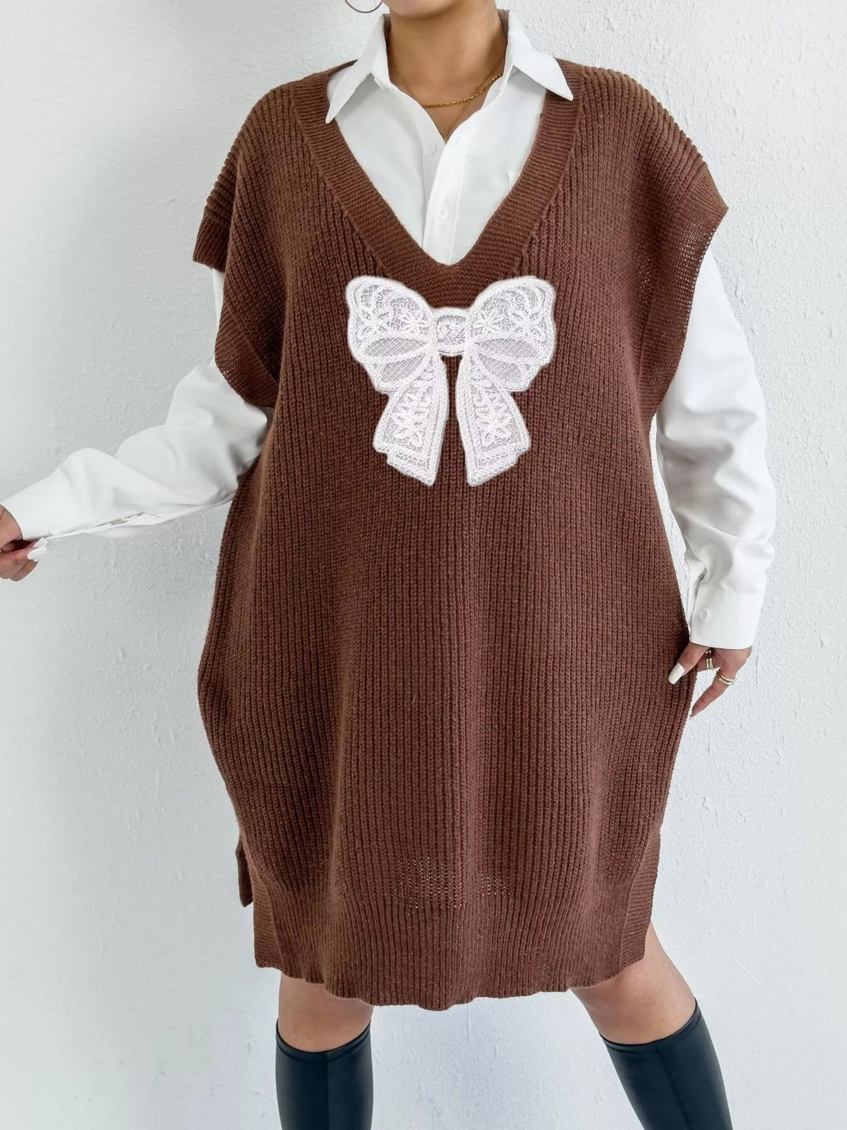 Embossed embroidered bow V-neck sweater vest by Trendsi, featuring a stylish design and detailed embroidery.