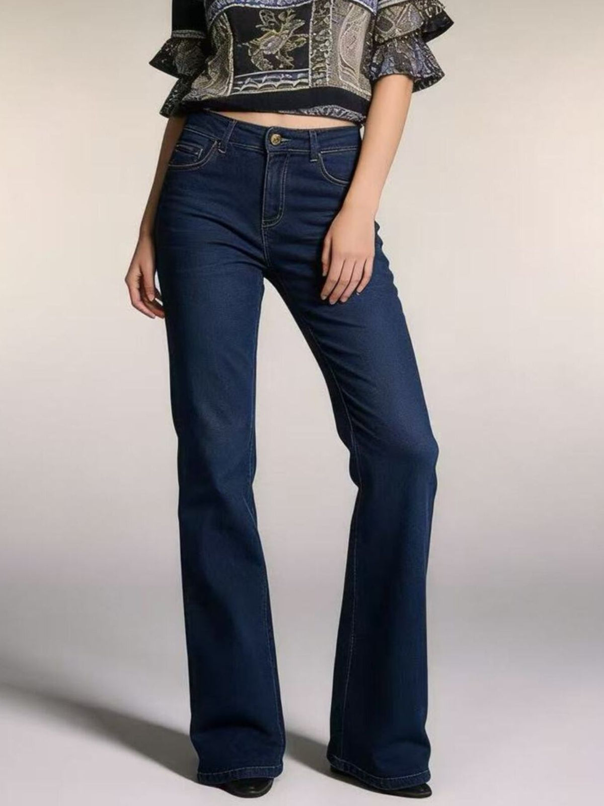 Plush Fashion Hub high-waisted bootcut denim jeans displayed on a hanger, showcasing classic blue wash and fitted waistband.