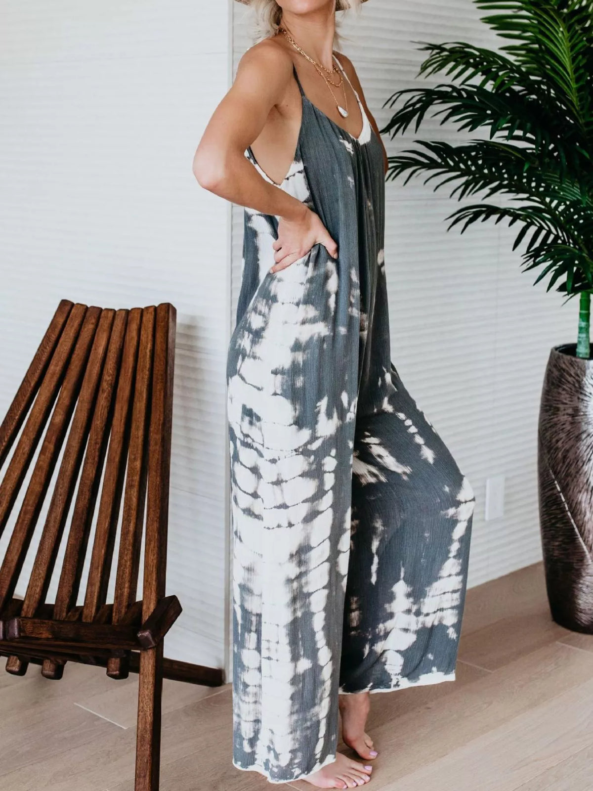Full size tie-dye wide leg jumpsuit by Plush Fashion Hub featuring a vibrant, casual plus-size one-piece with relaxed fit.