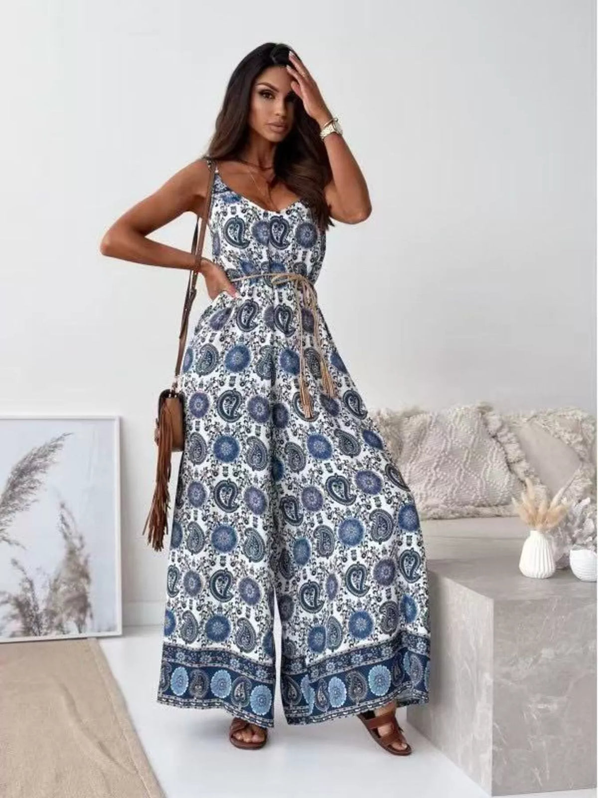 Printed spaghetti strap wide-leg jumpsuit by Plush Fashion Hub, featuring a stylish design and comfortable fit.