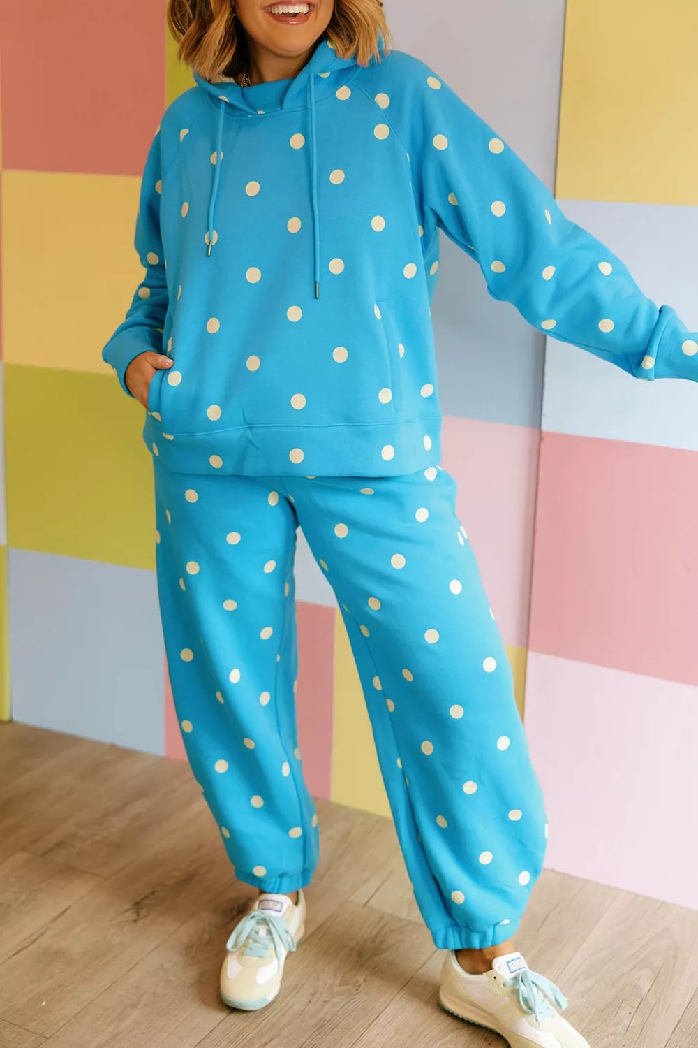 Plus size polka dot hooded drawstring long sleeve top and matching pants set by Trendsi, featuring a stylish polka dot pattern.