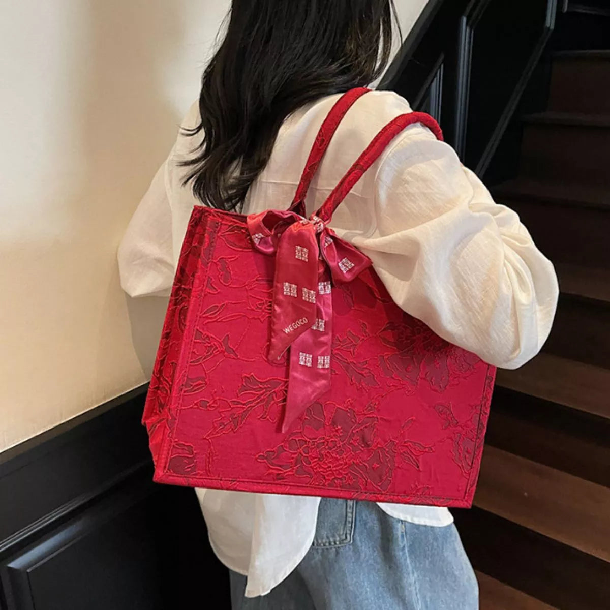 Floral embossed tote handbag with scarf accent by Plush Fashion Hub, showing the textured floral design and stylish accessory.