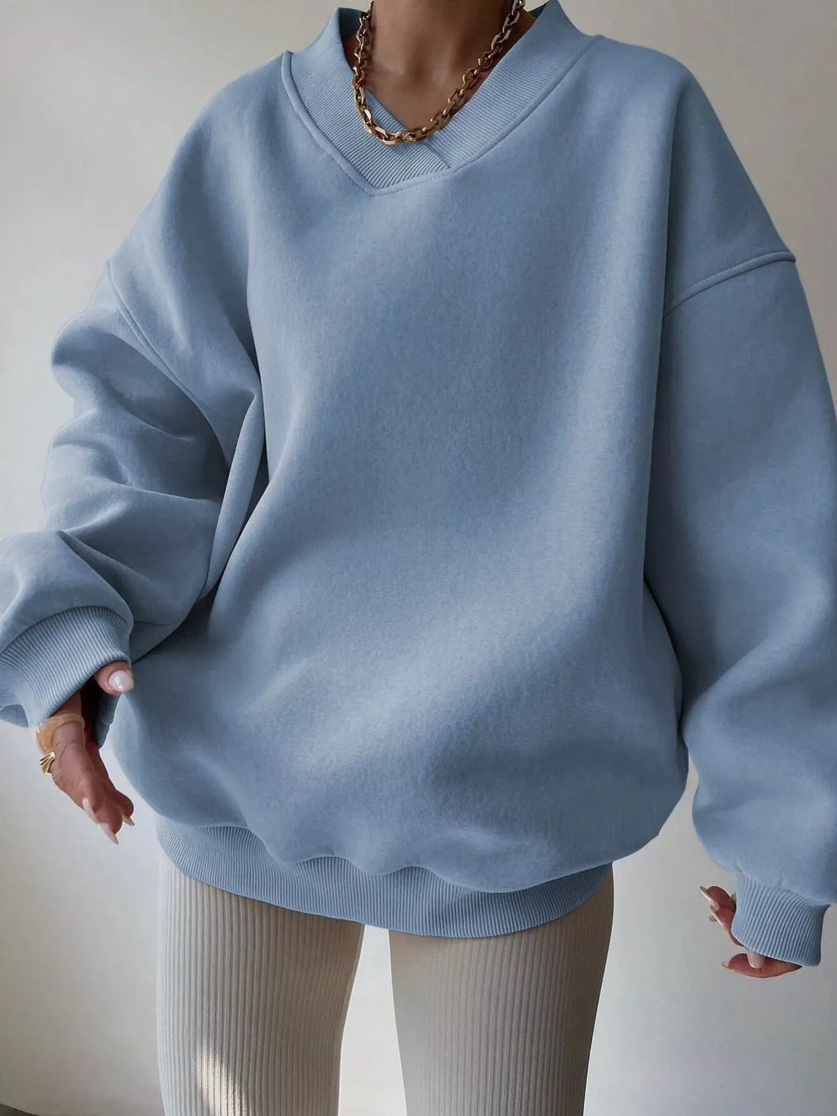 Oversized dropped shoulder long sleeve sweatshirt by Trendsi featuring a relaxed fit and casual style, shown in a front view.