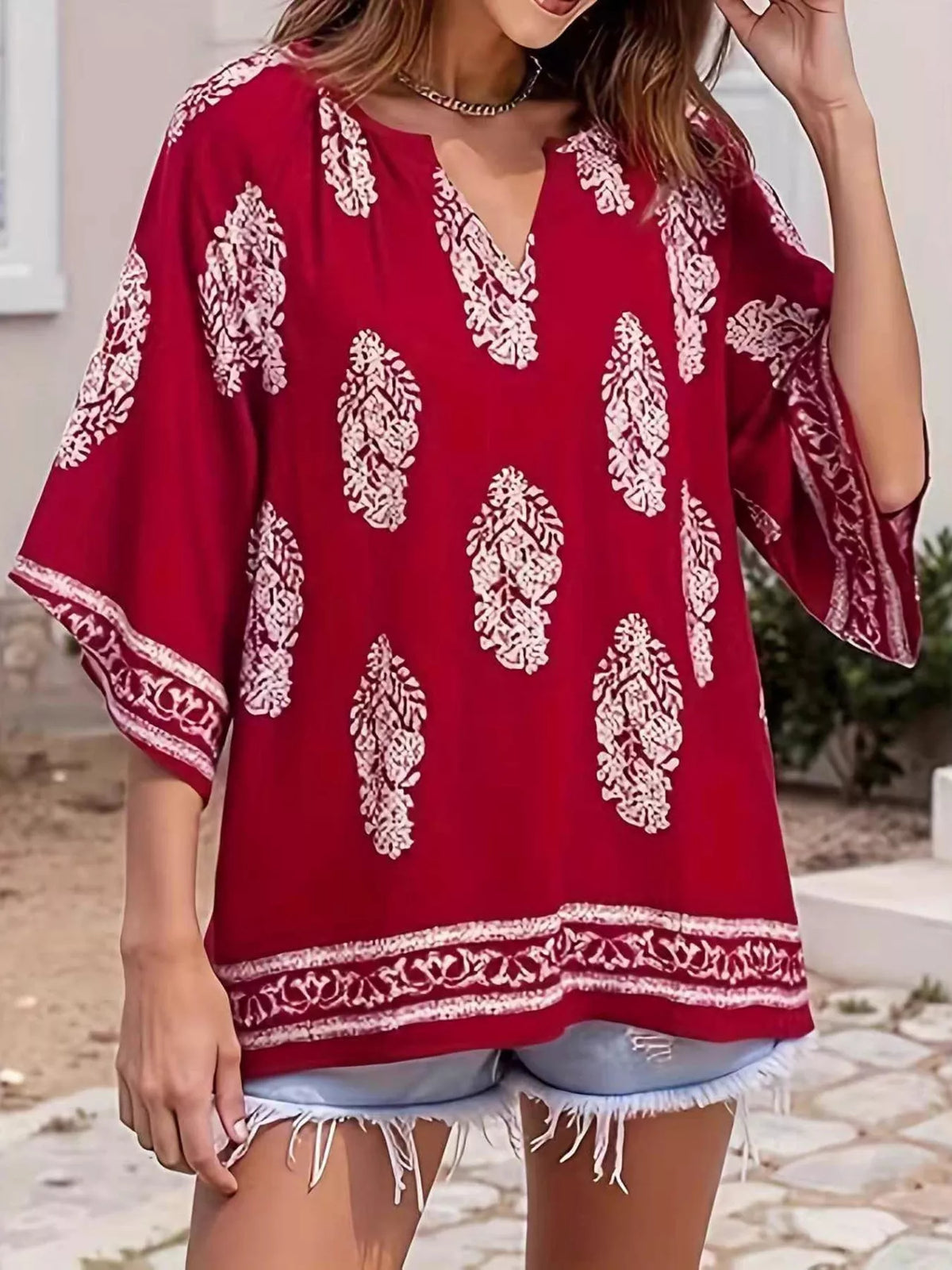 Printed notched 3/4 sleeve blouse from Plush Fashion Hub featuring a stylish design and comfortable fit.