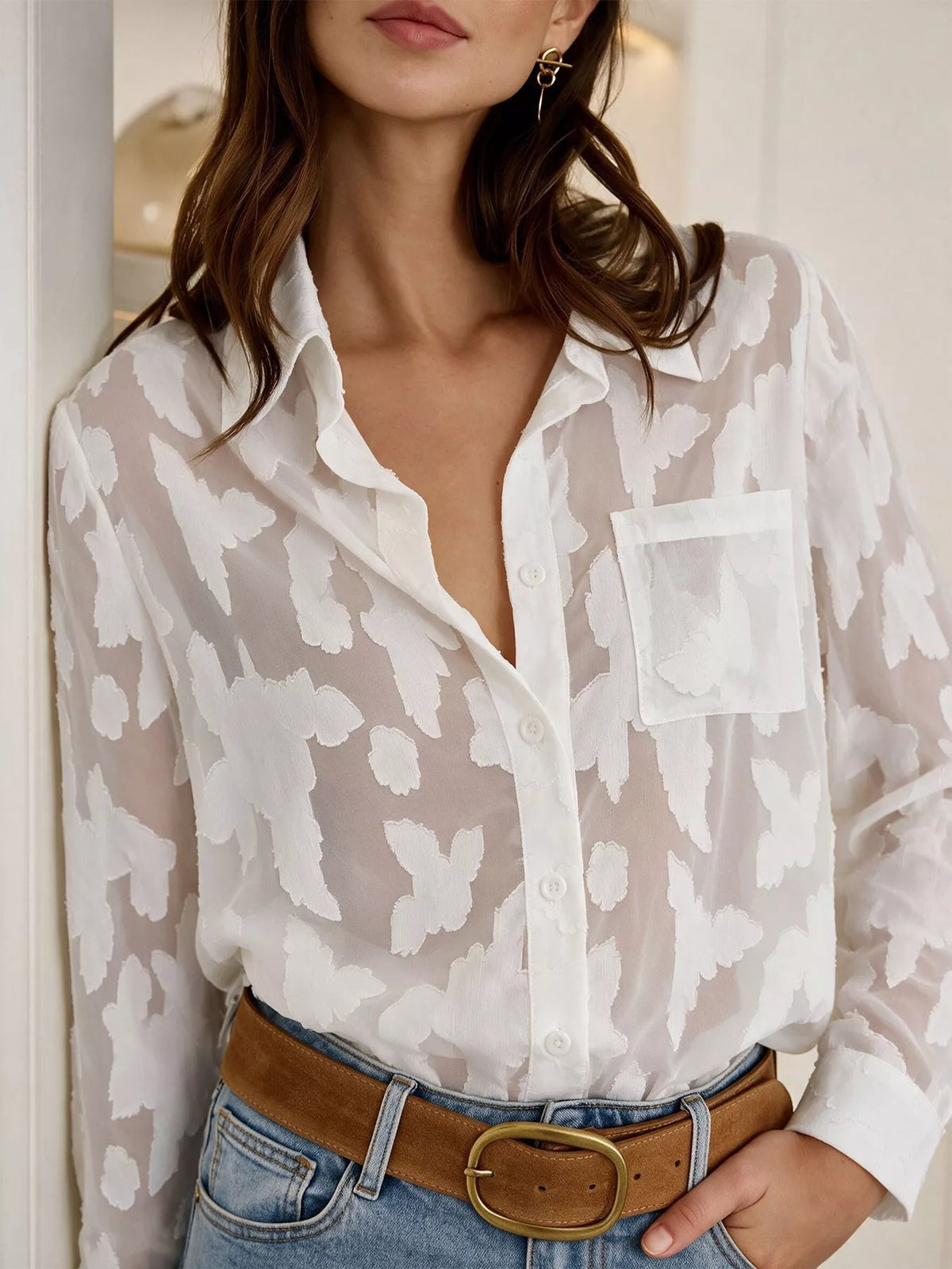 Sheer button-down shirt from Trendsi featuring long sleeves, collar, and transparent fabric, ideal for layered or stylish looks.