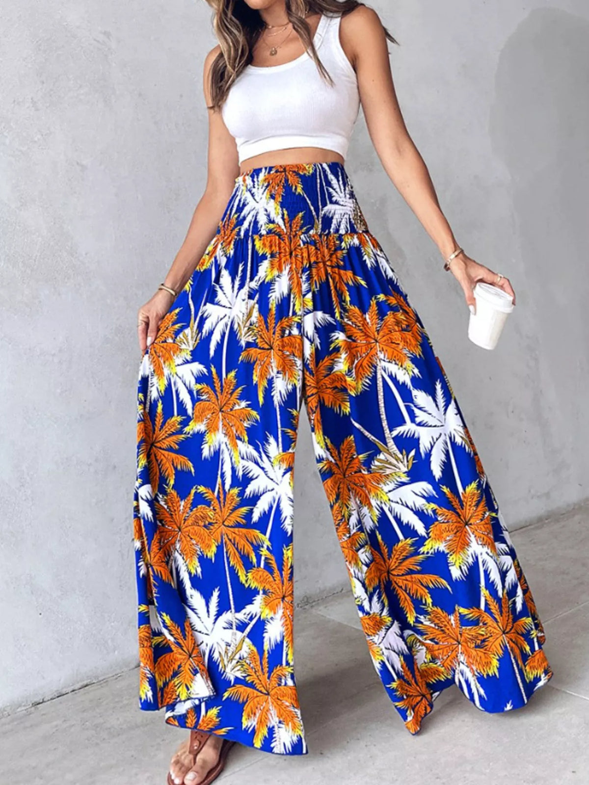 Printed wide-leg pants by Plush Fashion Hub featuring colorful floral patterns and a relaxed fit on model.