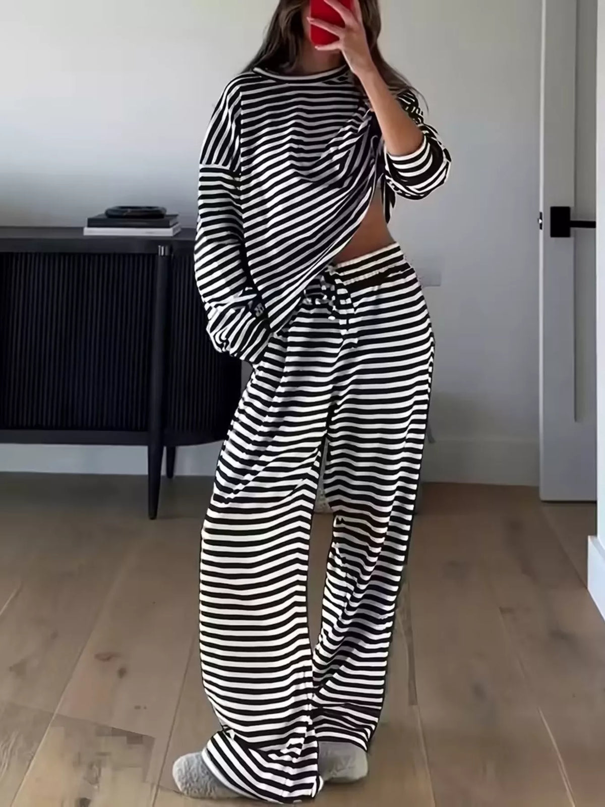 Striped dropped shoulder top and pants set by Trendsi, featuring a relaxed fit and stylish design, shown in the product image.
