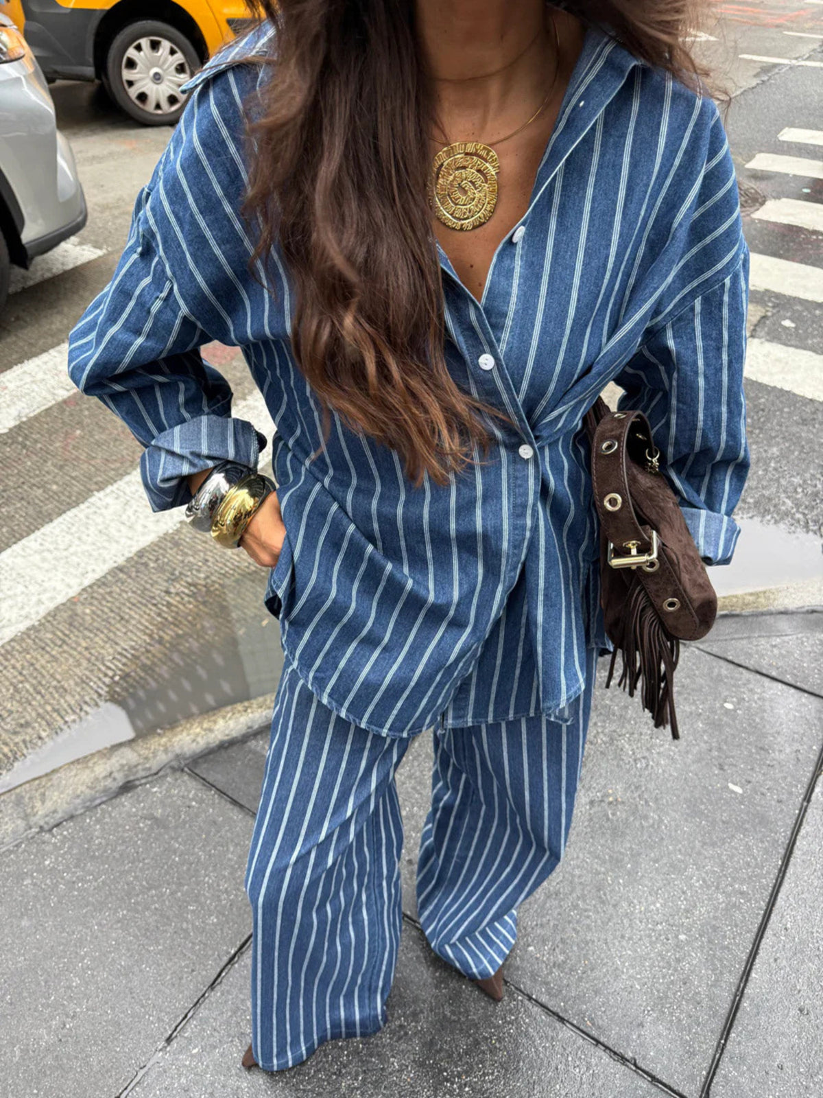 Women's striped button-up shirt and wide-leg pants two-piece set by Plush Fashion Hub, featuring a casual, stylish look.