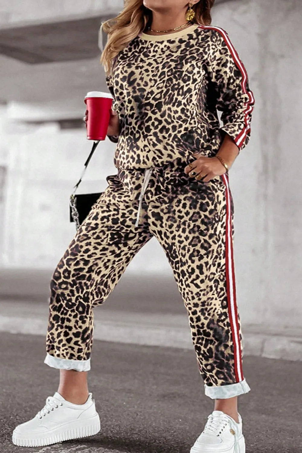 Plus size leopard print round neck top and pants set by Trendsi, featuring a stylish matching outfit with bold animal print.