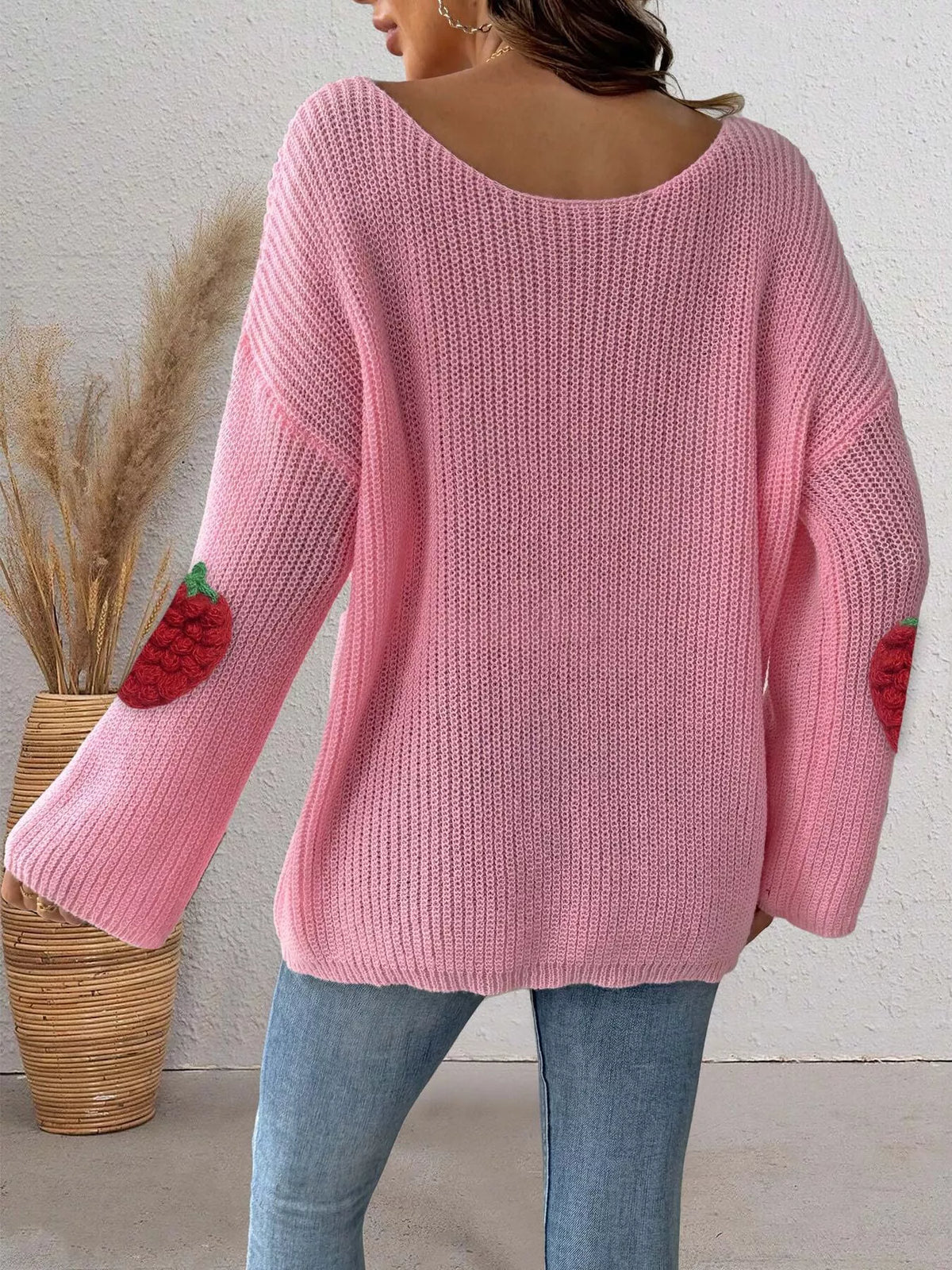 Oversized strawberry applique sweater from Trendsi featuring a cozy knit design and playful fruit embellishment.