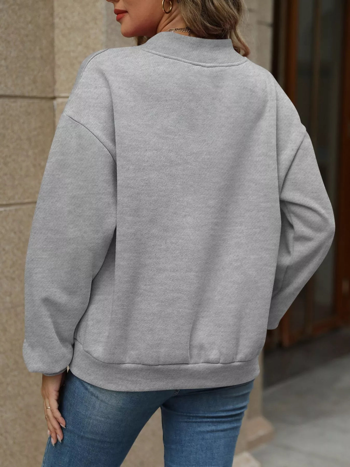 V-neck solid color casual sweatshirt by Trendsi, shown in image with relaxed fit and soft fabric in a neutral tone.