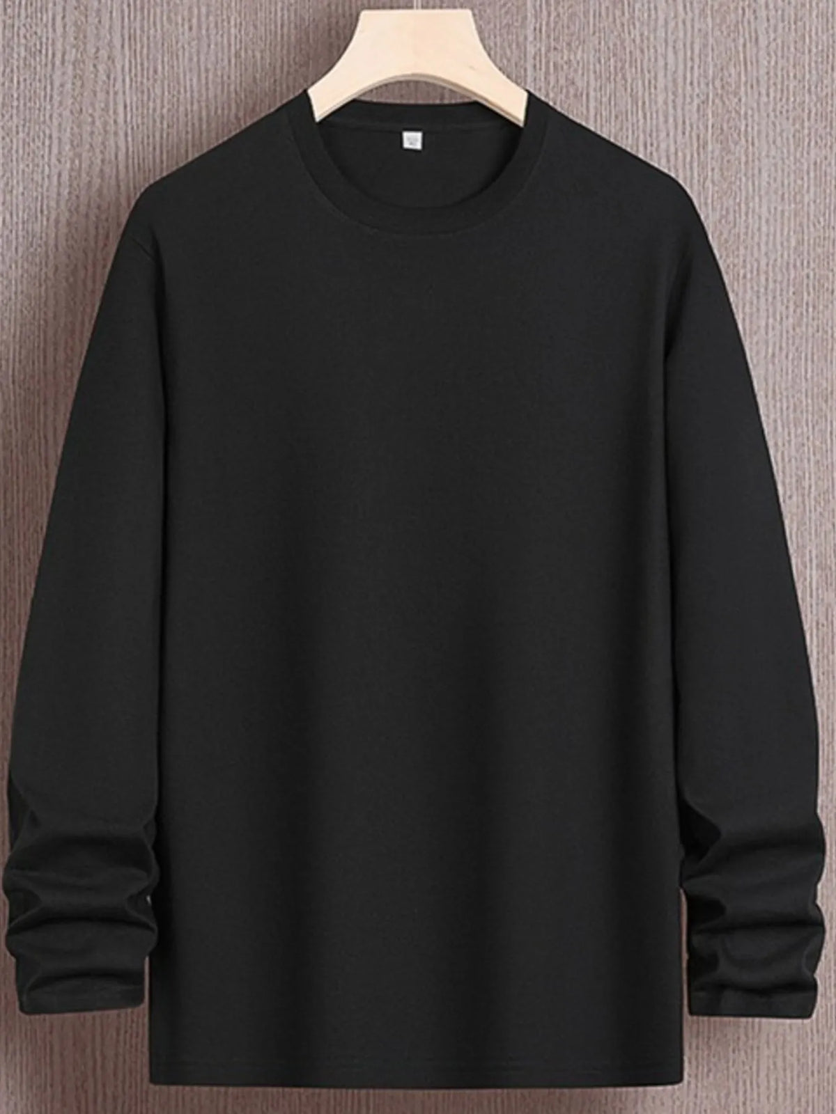 Plus size men's round neck long sleeve T-shirt from Trendsi, featuring a comfortable casual fit and soft fabric.
