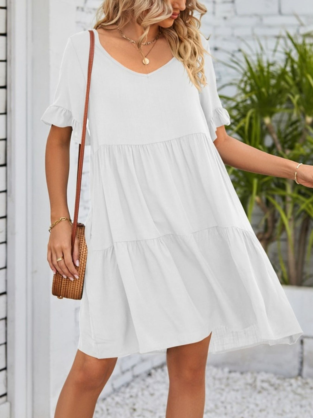 Lightweight rayon ruffled sleeve tiered mini dress with pockets from Plush Fashion Hub, shown on a model in a casual setting.