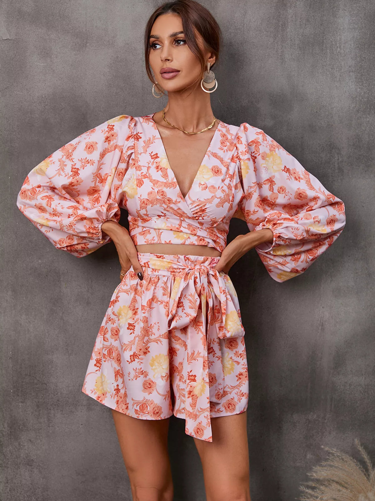 Printed long sleeve romper with cutout front, stylish jumpsuit by Plush Fashion Hub, shown in a vibrant design.
