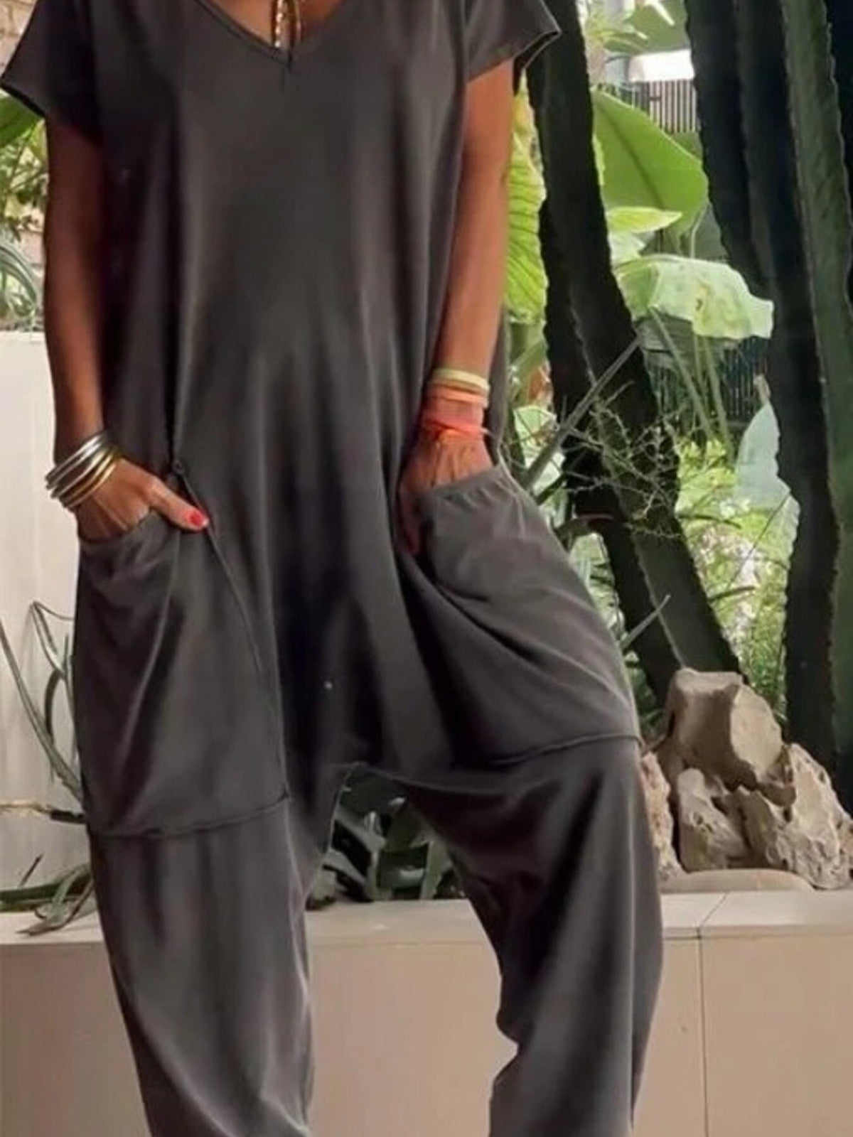 Plus size loose fit V-neck short sleeve jumpsuit with wide legs, trendy and comfortable, from Trendsi.