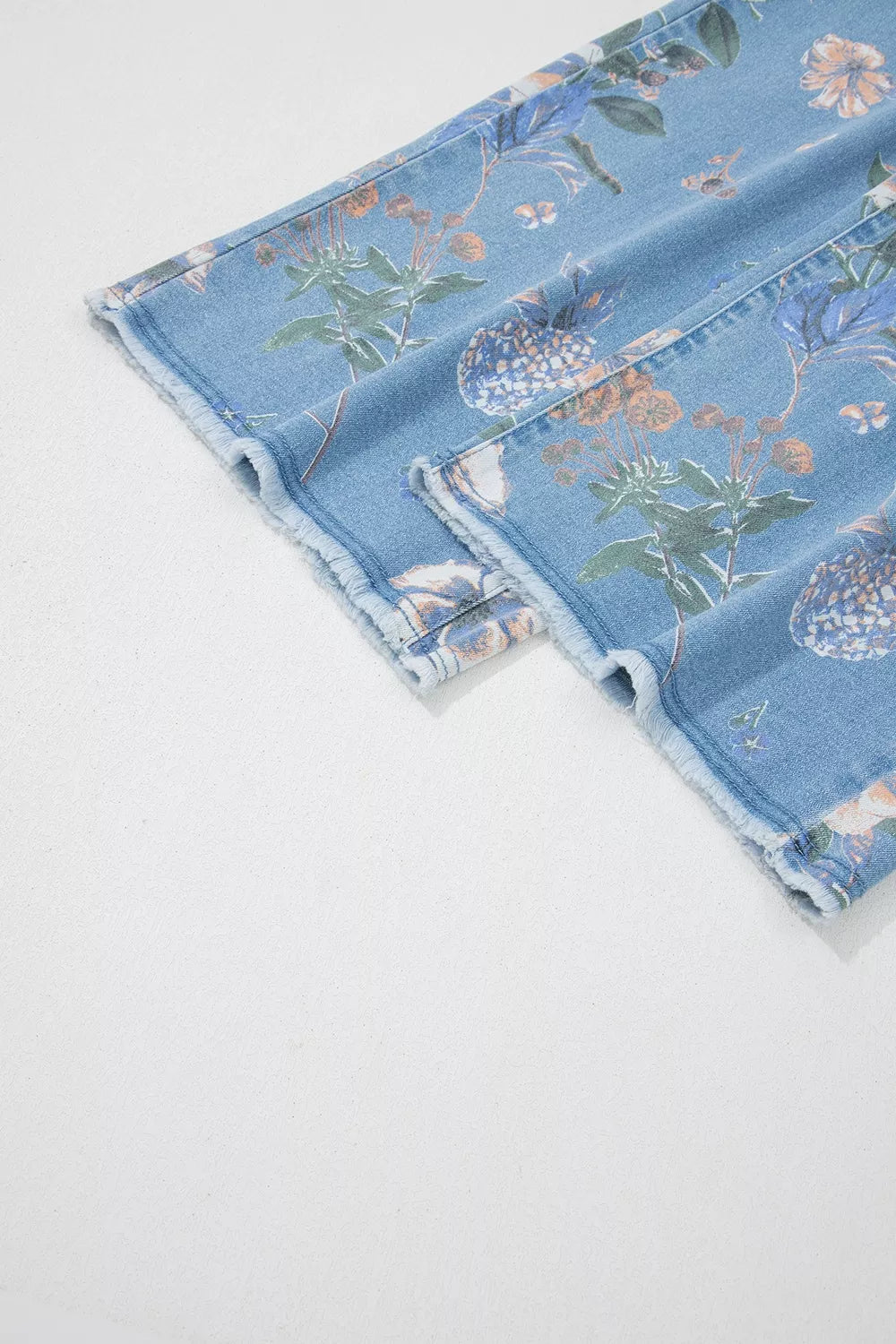 Floral print wide-leg jeans from Trendsi, showing a stylish denim design with colorful floral patterns and relaxed fit.