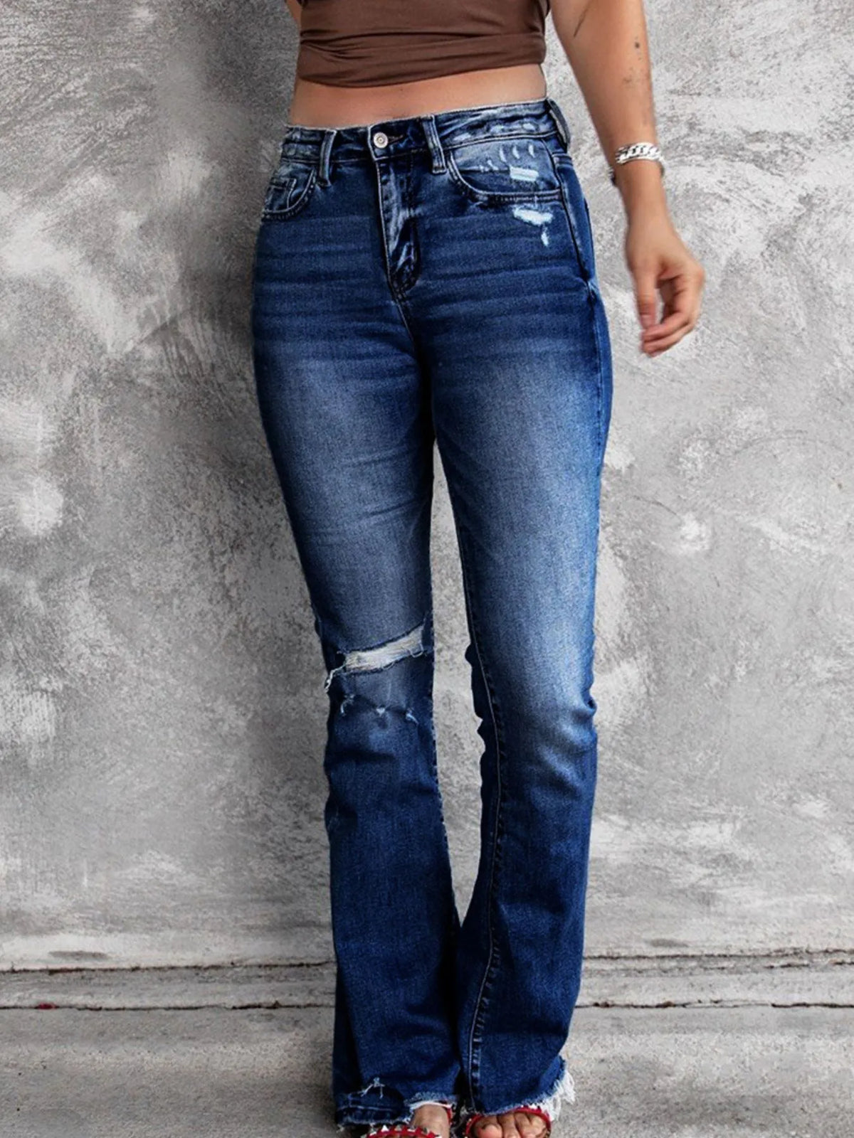 Distressed flare denim jeans from Plush Fashion Hub featuring ripped details and a high-waisted fit.