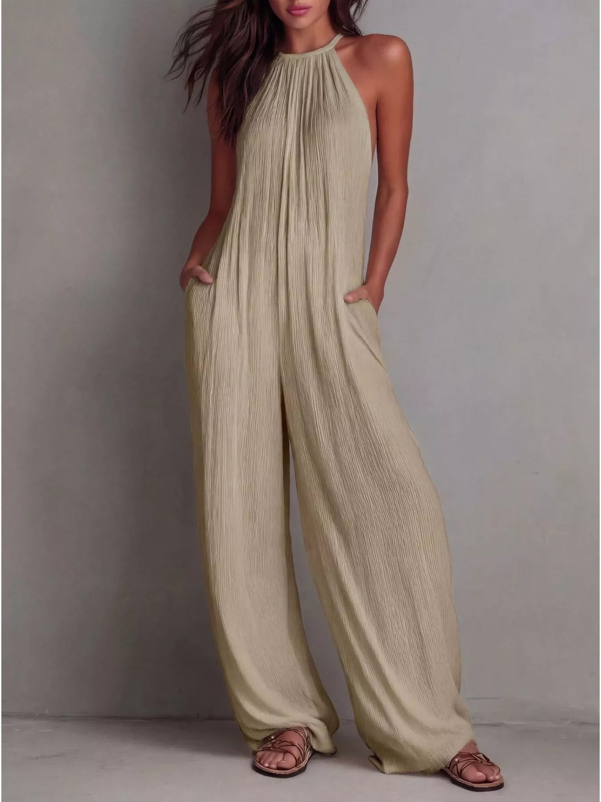 Sleeveless wide-leg jumpsuit by Plush Fashion Hub, featuring a relaxed fit and stylish design, shown on a model.