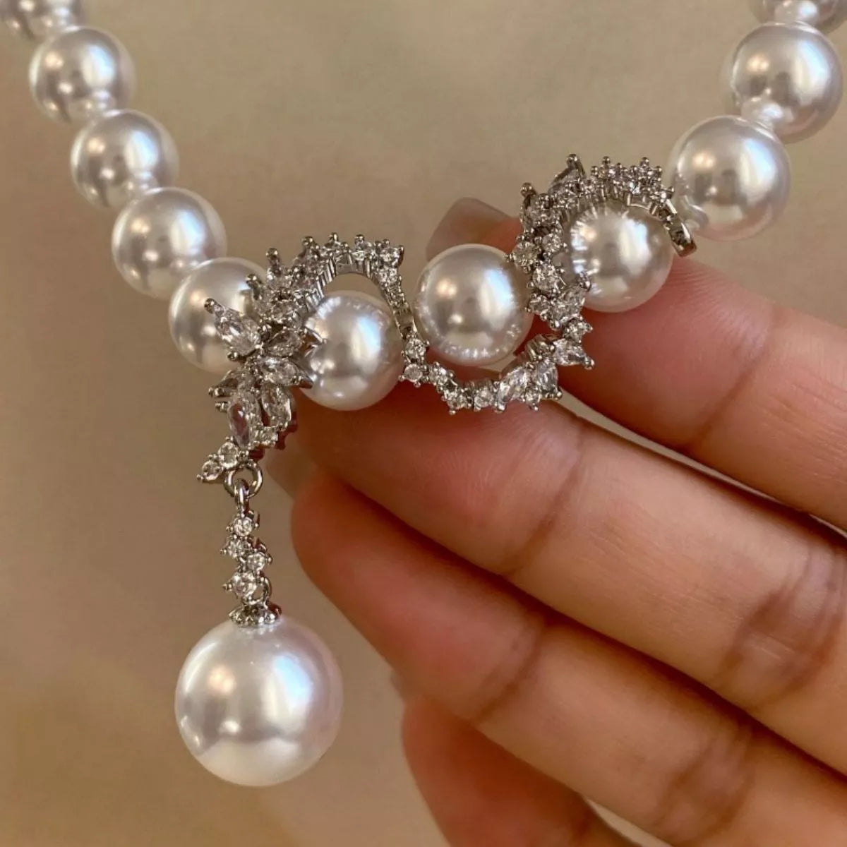 Elegant zircon pearl necklace from Plush Fashion Hub featuring a string of shimmering pearls and sparkling zircon accents.
