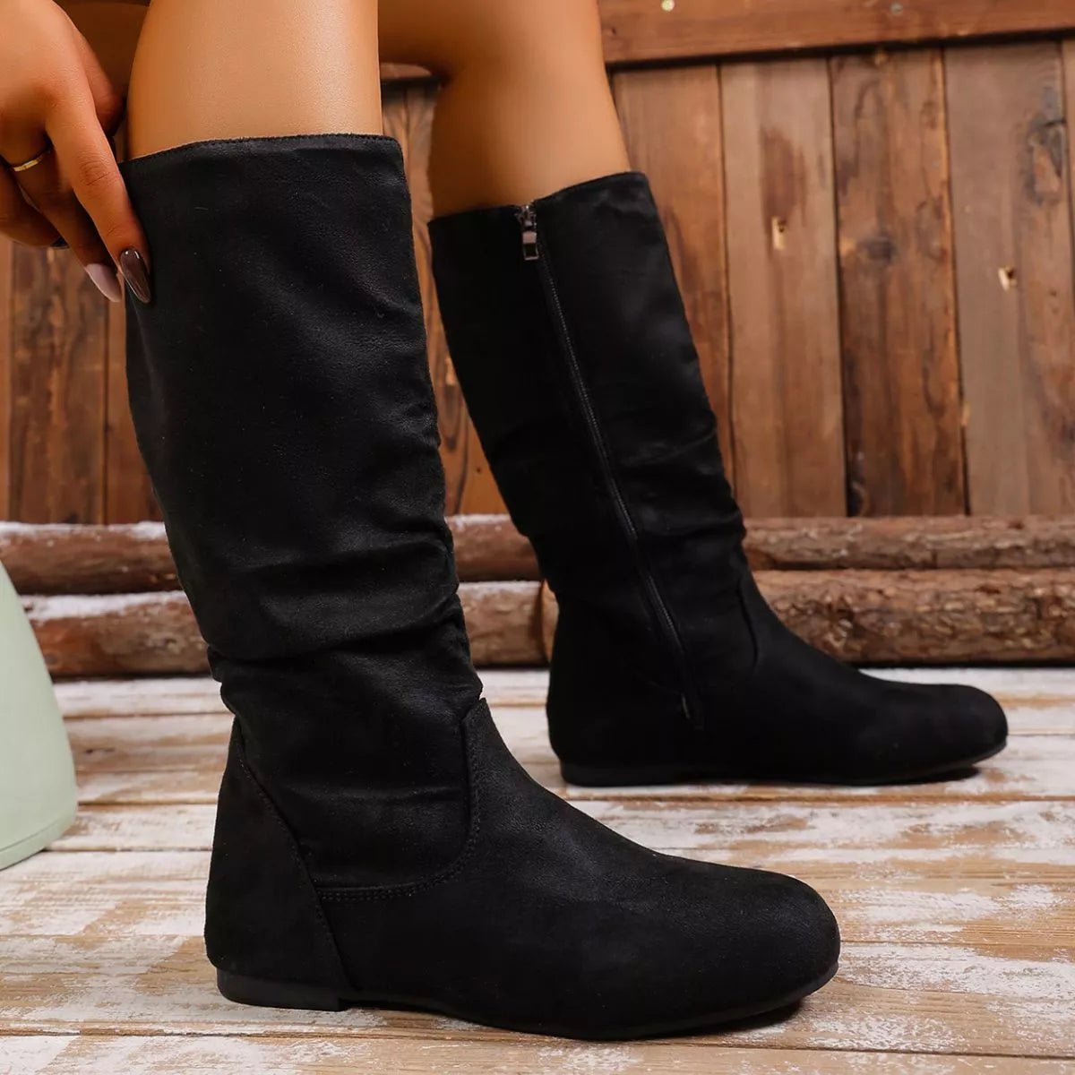 Black round toe side zip boots by Trendsi featuring a sleek design and sturdy heel, perfect for stylish fall and winter outfits.