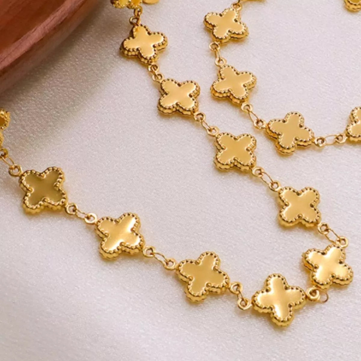 Gold-plated clover charm necklace from Plush Fashion Hub featuring a delicate chain and a four-leaf clover pendant.
