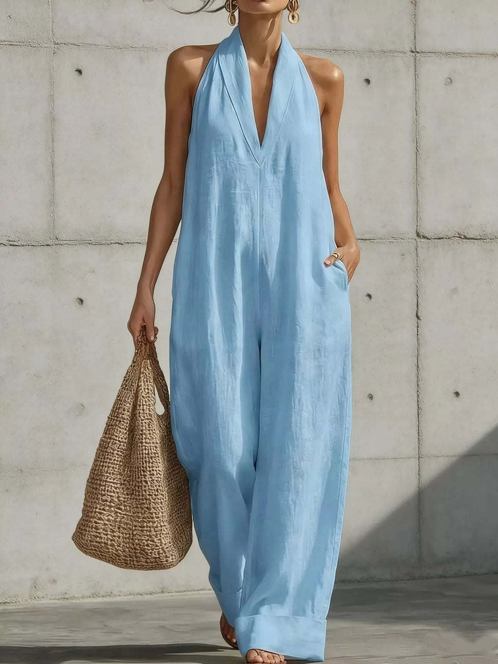 Plus size full-length halter neck jumpsuit with wide-leg design by Trendsi, shown in a stylish, comfortable look.