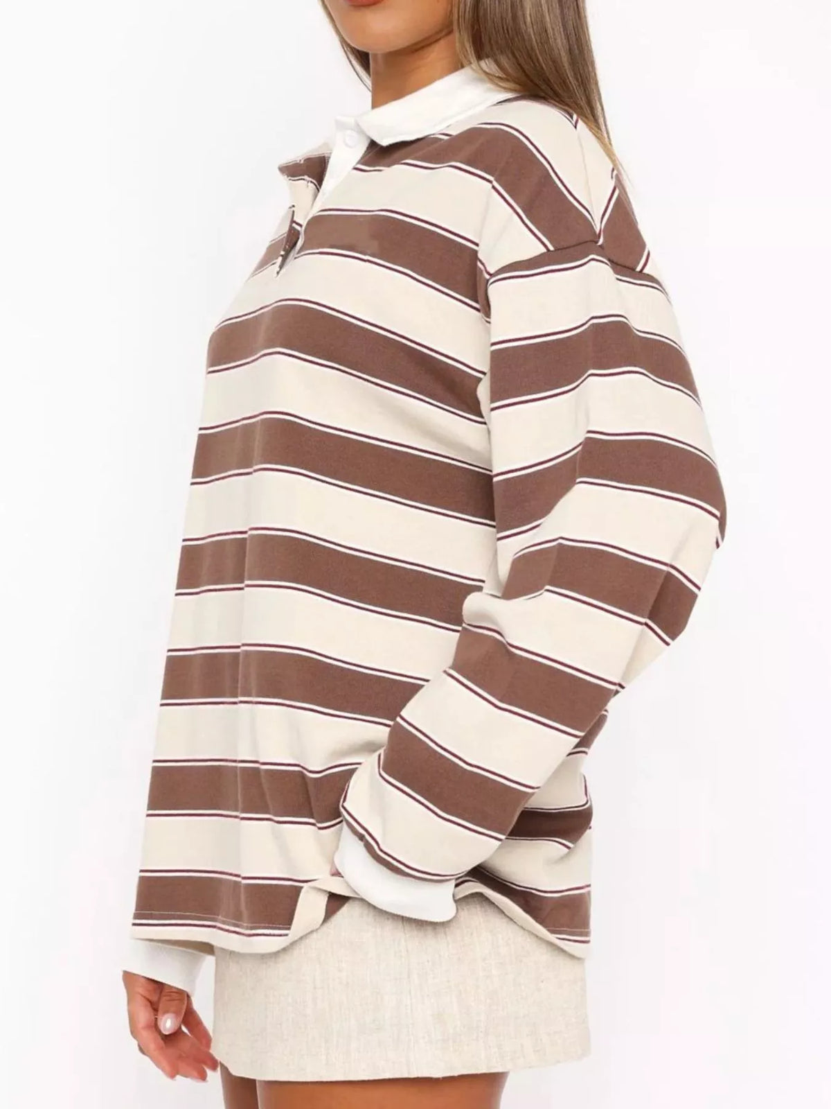 Striped long sleeve polo shirt with button details from Plush Fashion Hub, featuring a classic collar and stylish striped pattern.