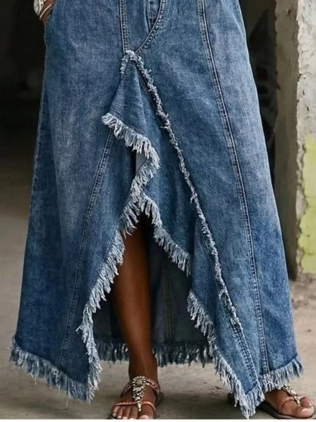 Plus size off-shoulder raw hem slit denim maxi dress by Trendsi, featuring a stylish full-length denim design with a slit detail.