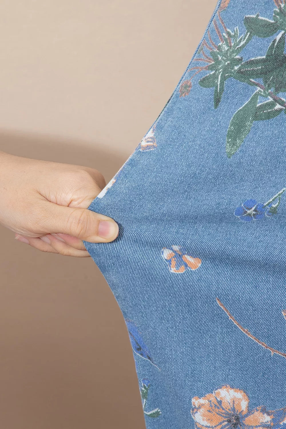 Floral print wide-leg jeans from Trendsi featuring a relaxed fit and colorful floral patterns on denim.
