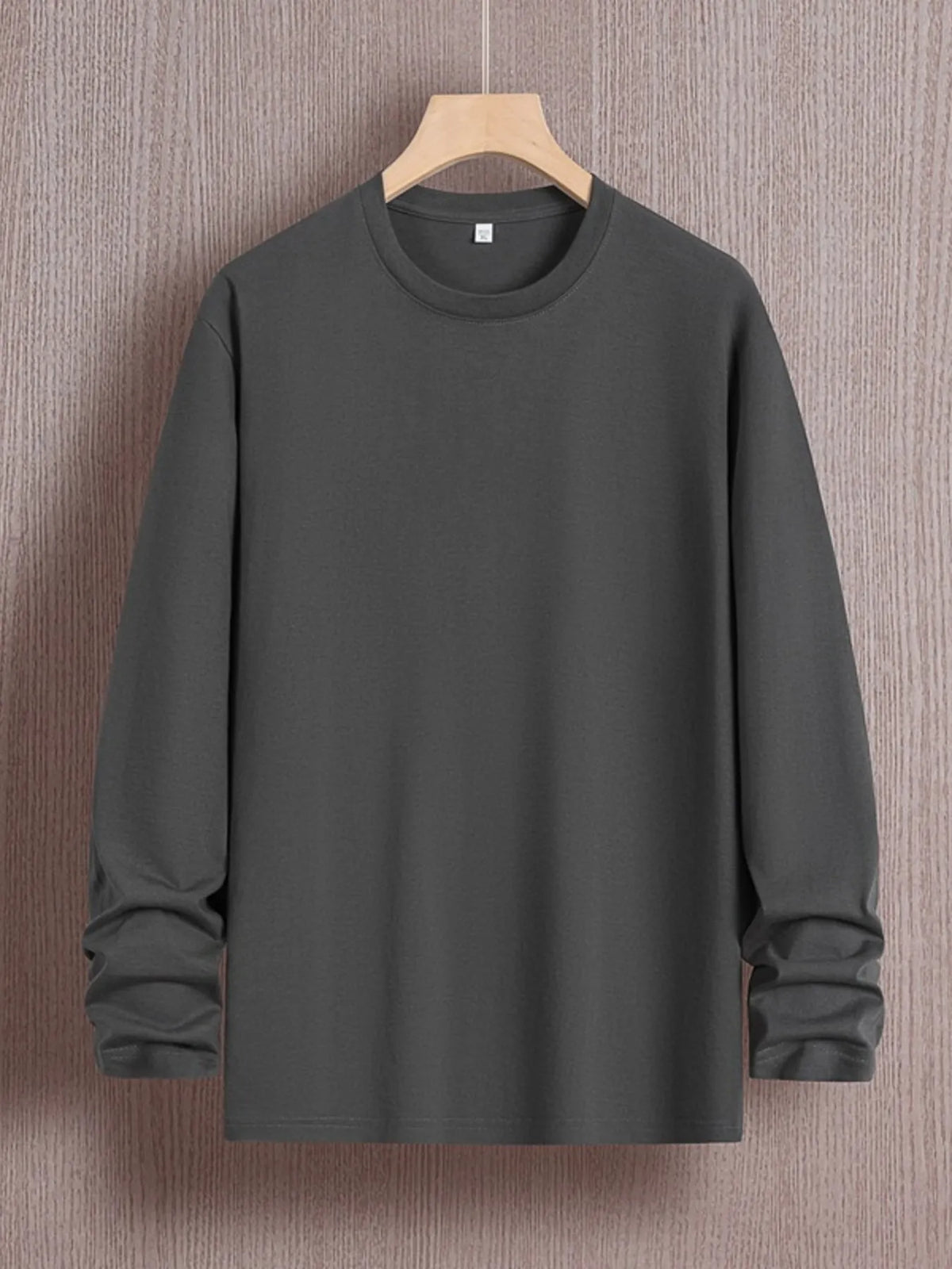 Men's plus size round neck long sleeve T-shirt from Trendsi, in a comfortable fit, shown on a model with neutral background.