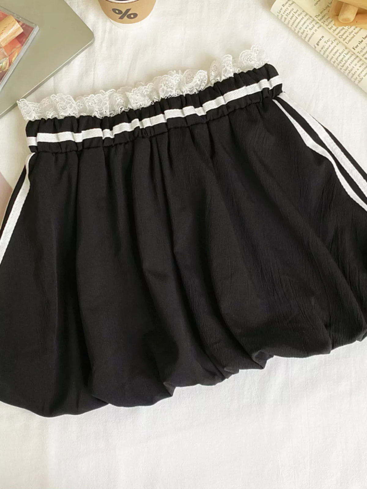 Plush Fashion Hub lace trim elastic waist mini skirt showing a stylish black skirt with delicate lace detail and stretchy waistband.