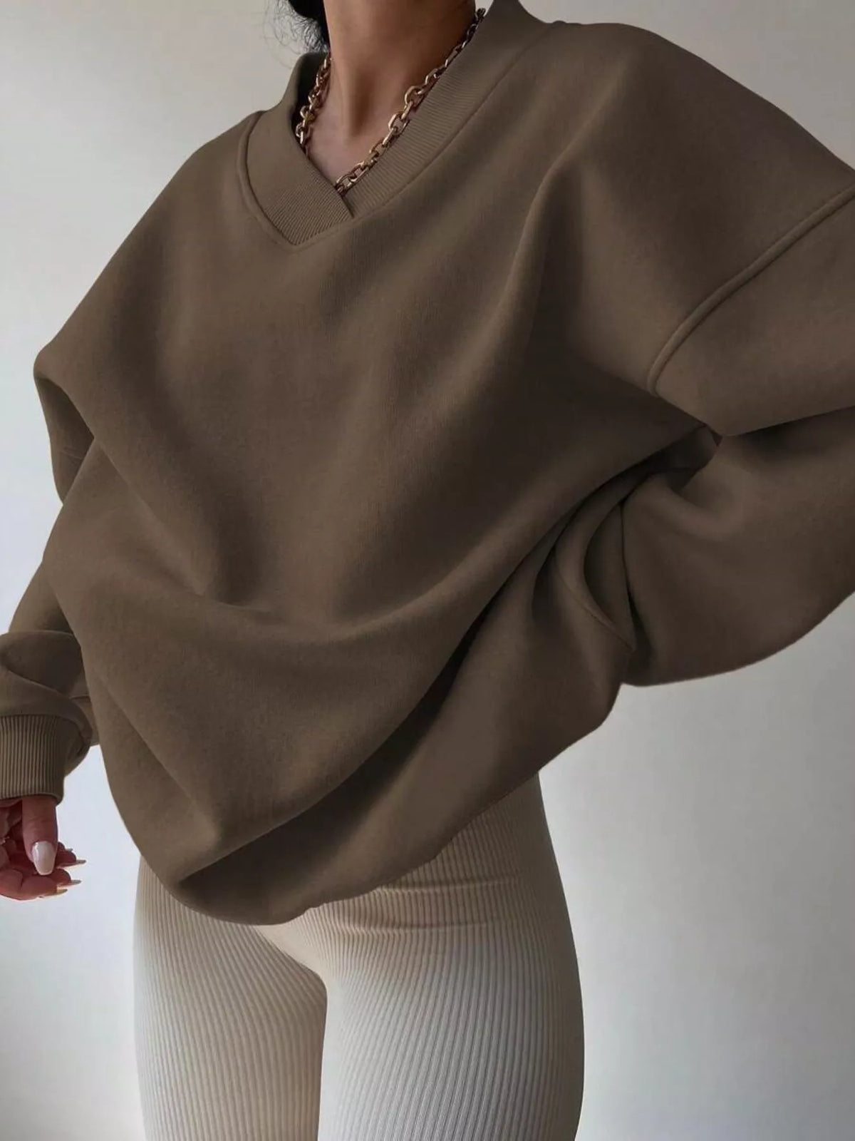 Oversized dropped shoulder long sleeve sweatshirt from Trendsi, featuring a relaxed fit and casual style.