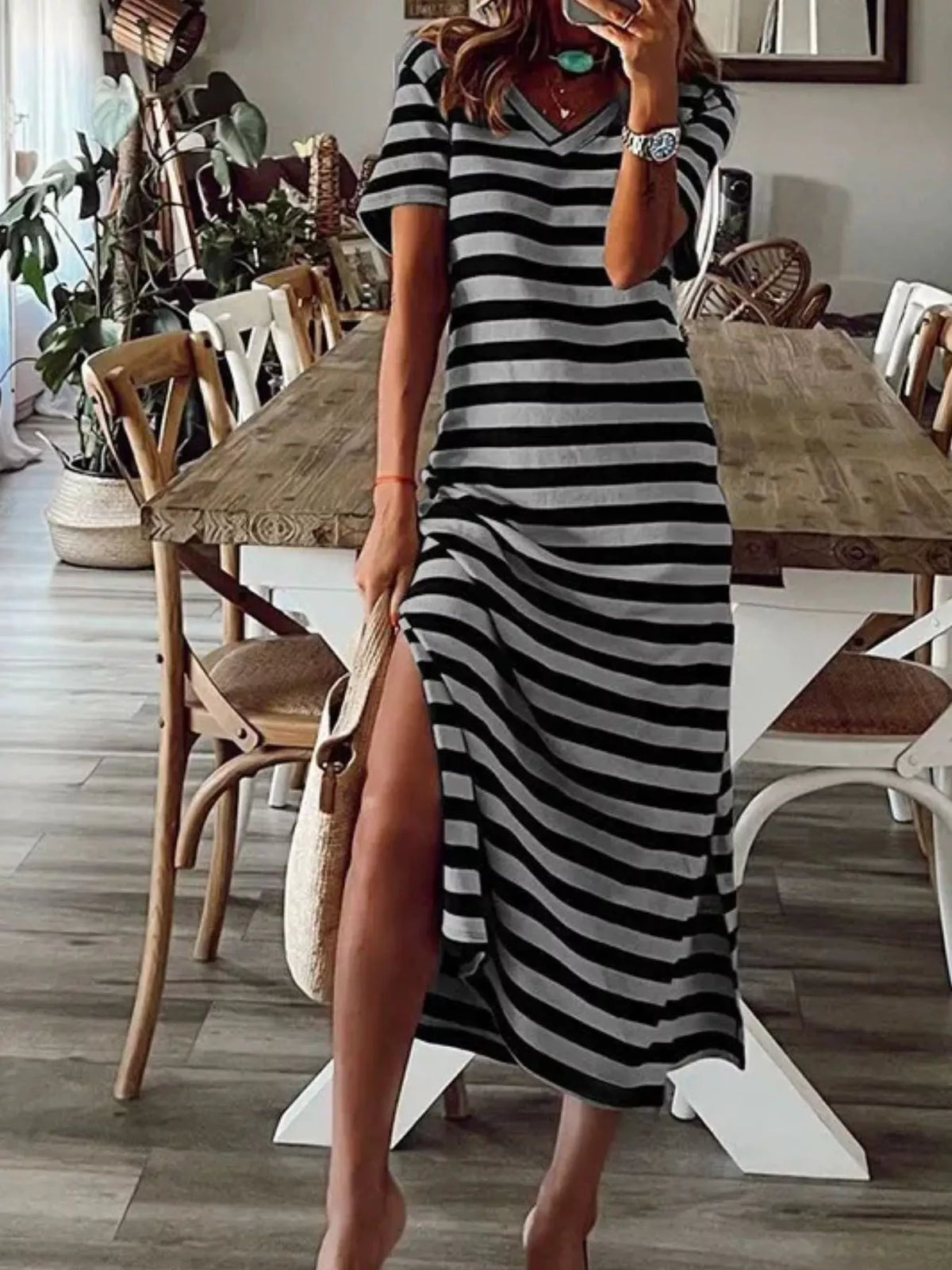 Plus size striped V-neck midi dress with side slit, featuring a flowing silhouette and trendy design from Trendsi.