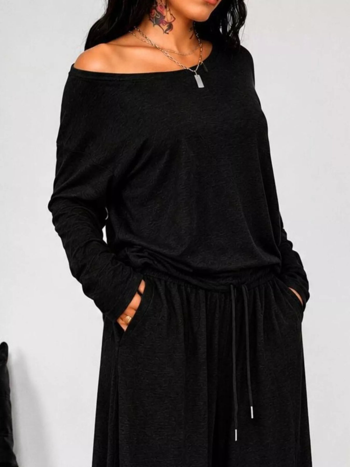 Plus size loose-fit one-shoulder T-shirt and pants matching set by Trendsi, casual and comfortable fashion ensemble.