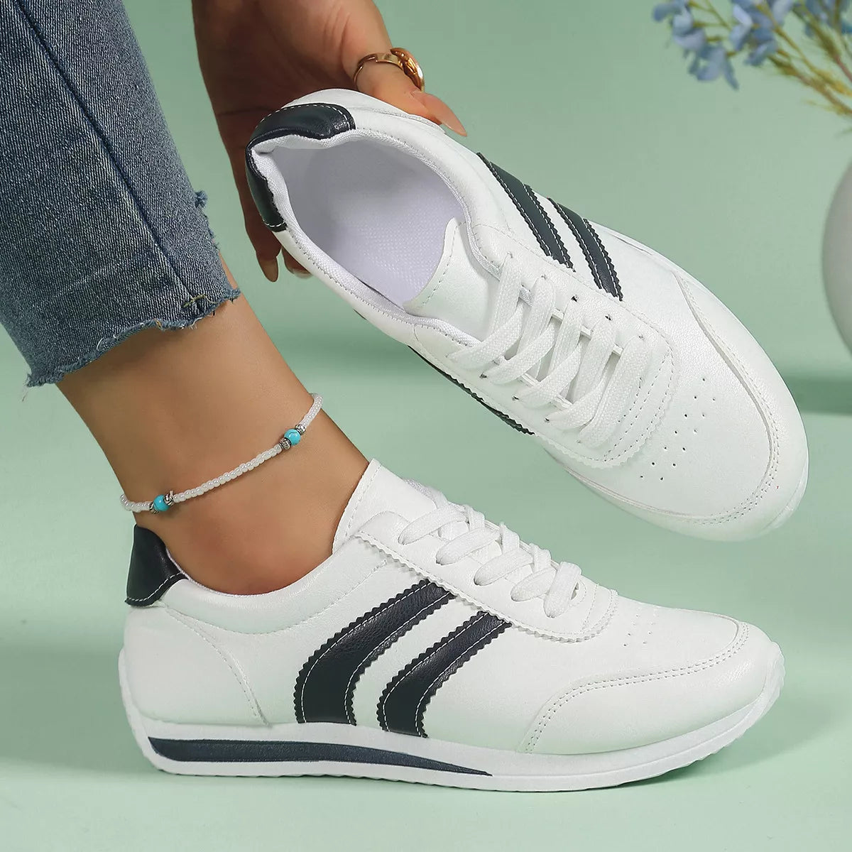 Women’s round toe lace-up sneakers by Trendsi, featuring a stylish design and comfortable fit in a casual sneaker style.