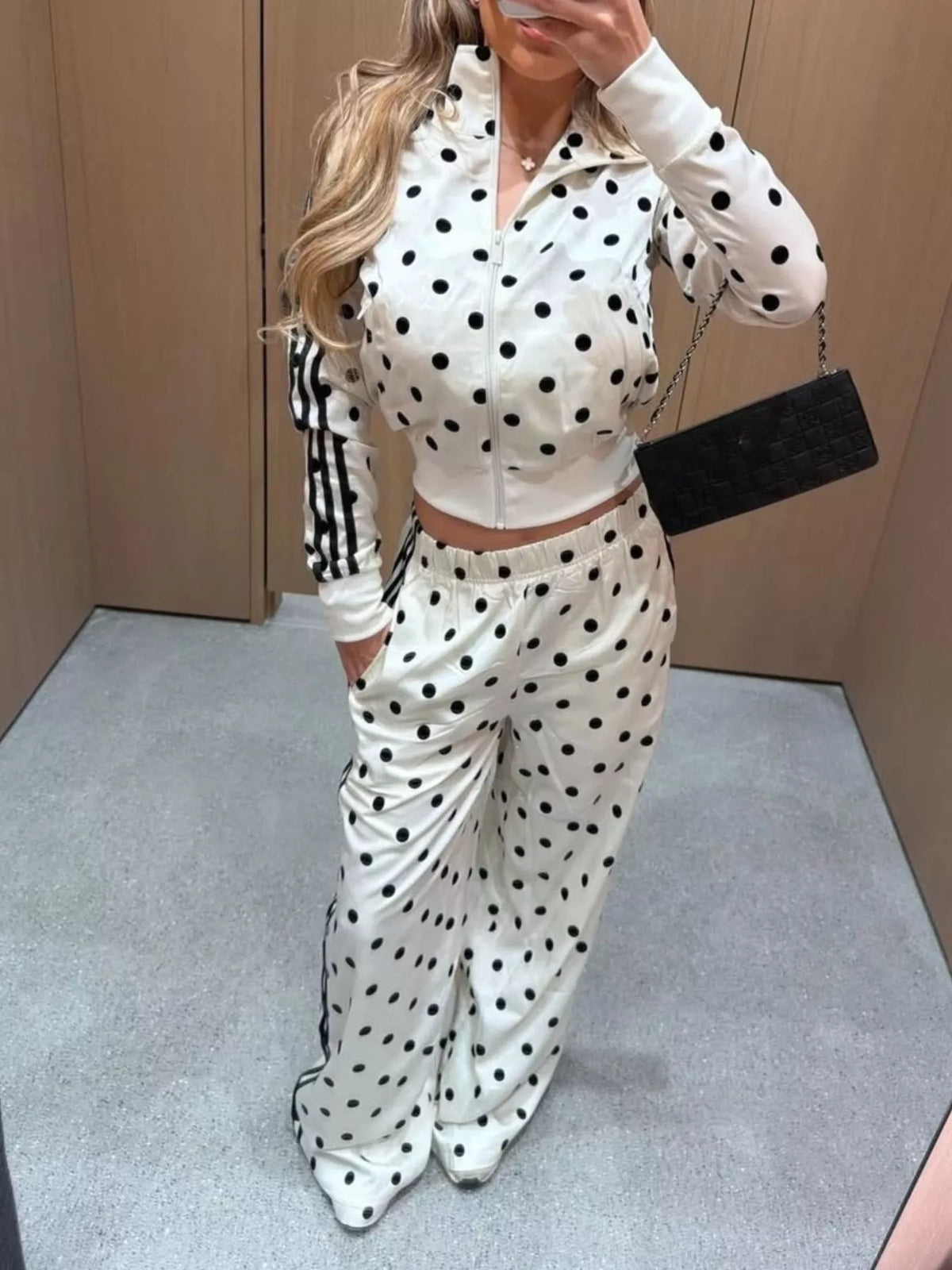 Polka dot zip-up outerwear and pants matching set by Plush Fashion Hub, featuring a stylish polka dot pattern and comfortable fit.