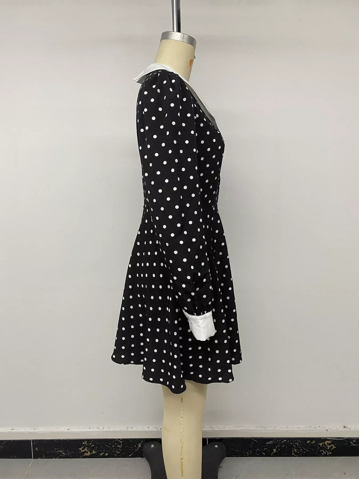 Polka dot Peter Pan collar dress by Plush Fashion Hub, featuring a classic design with a rounded collar and polka dot pattern.