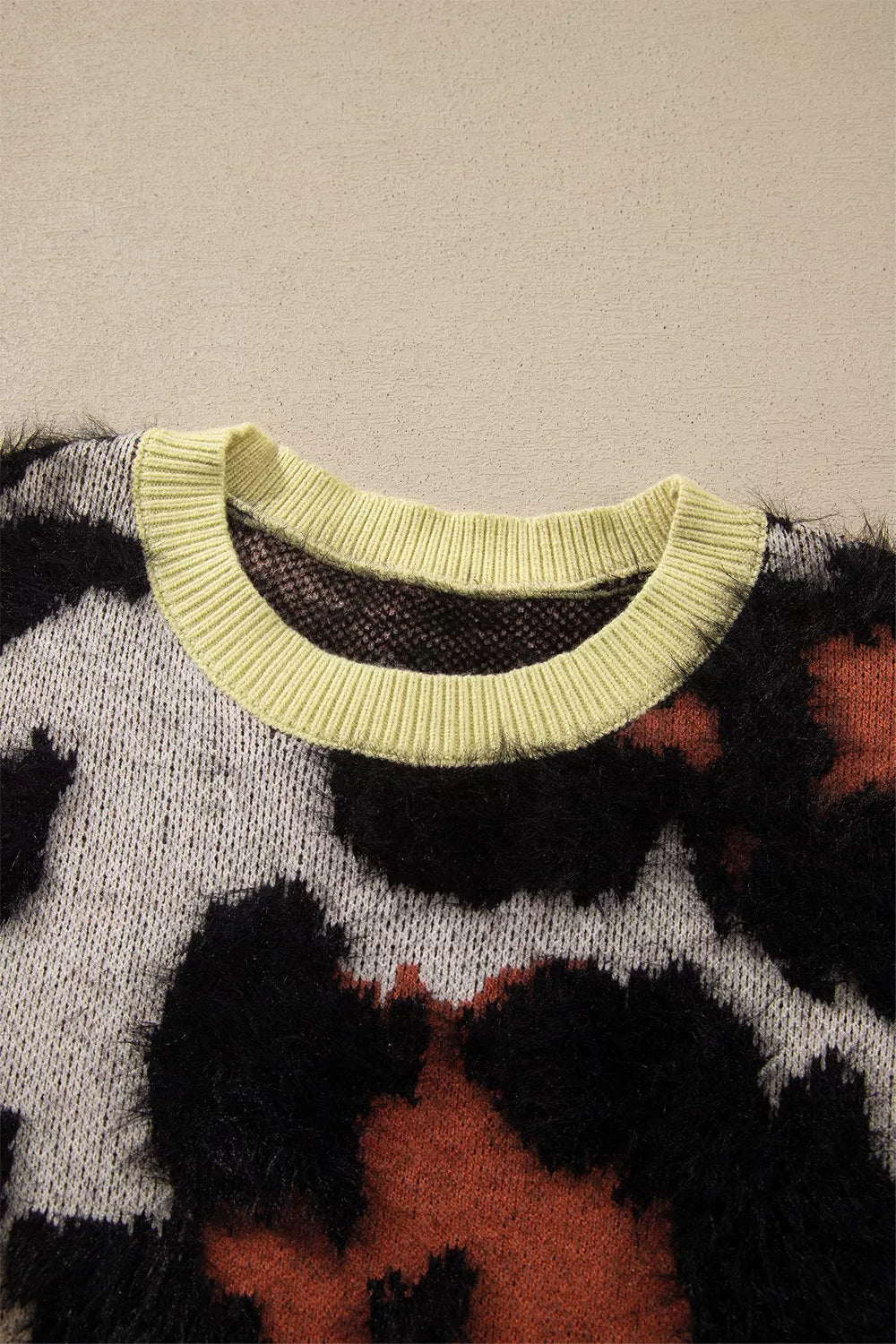 Leopard print drop shoulder long sleeve sweater with round neck from Trendsi, featuring a cozy fit and stylish animal pattern.