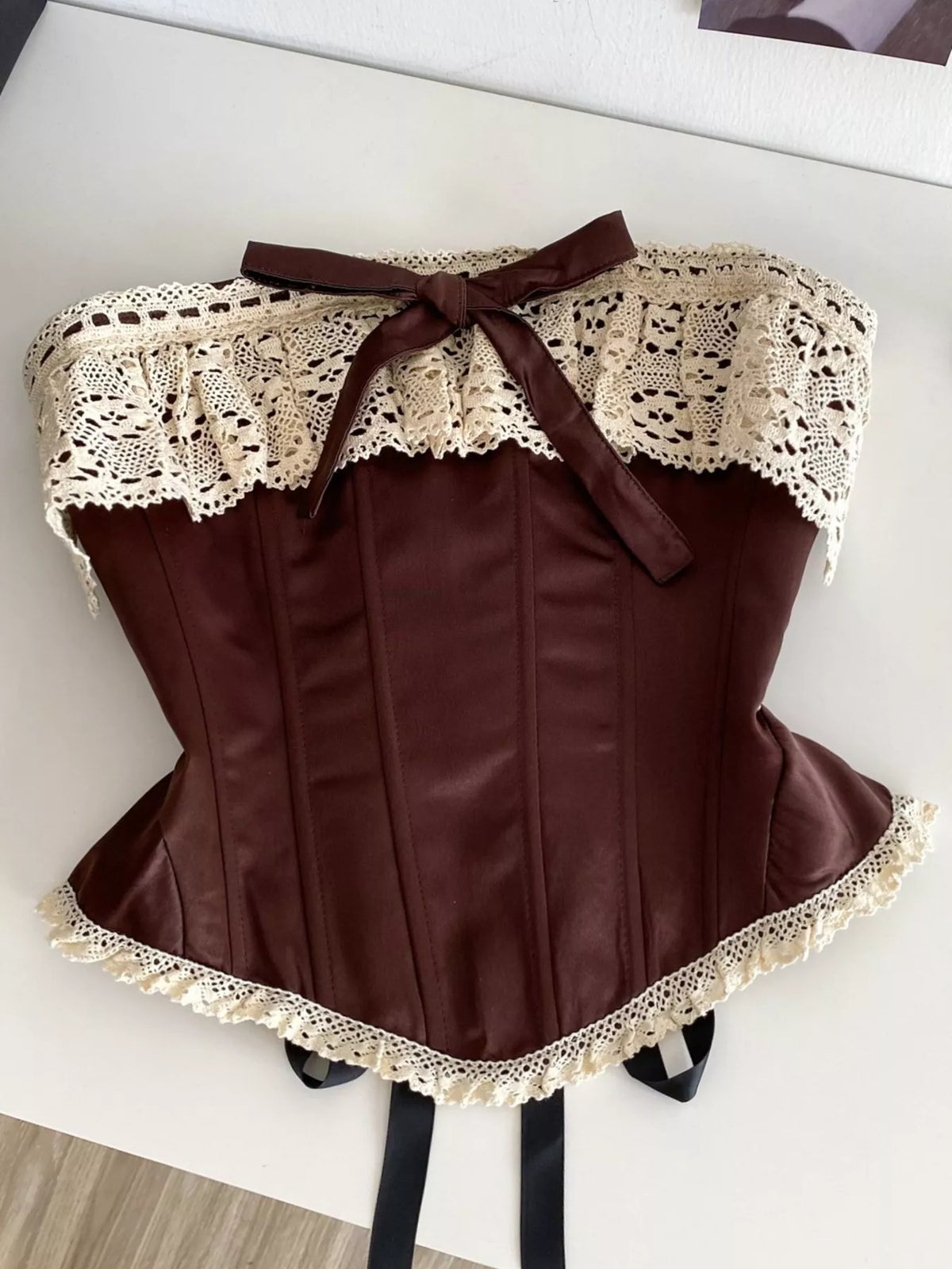 Crochet lace strapless corset with boning and lace-up waist, Trendsi tube top featuring intricate lace details and a fitted design.