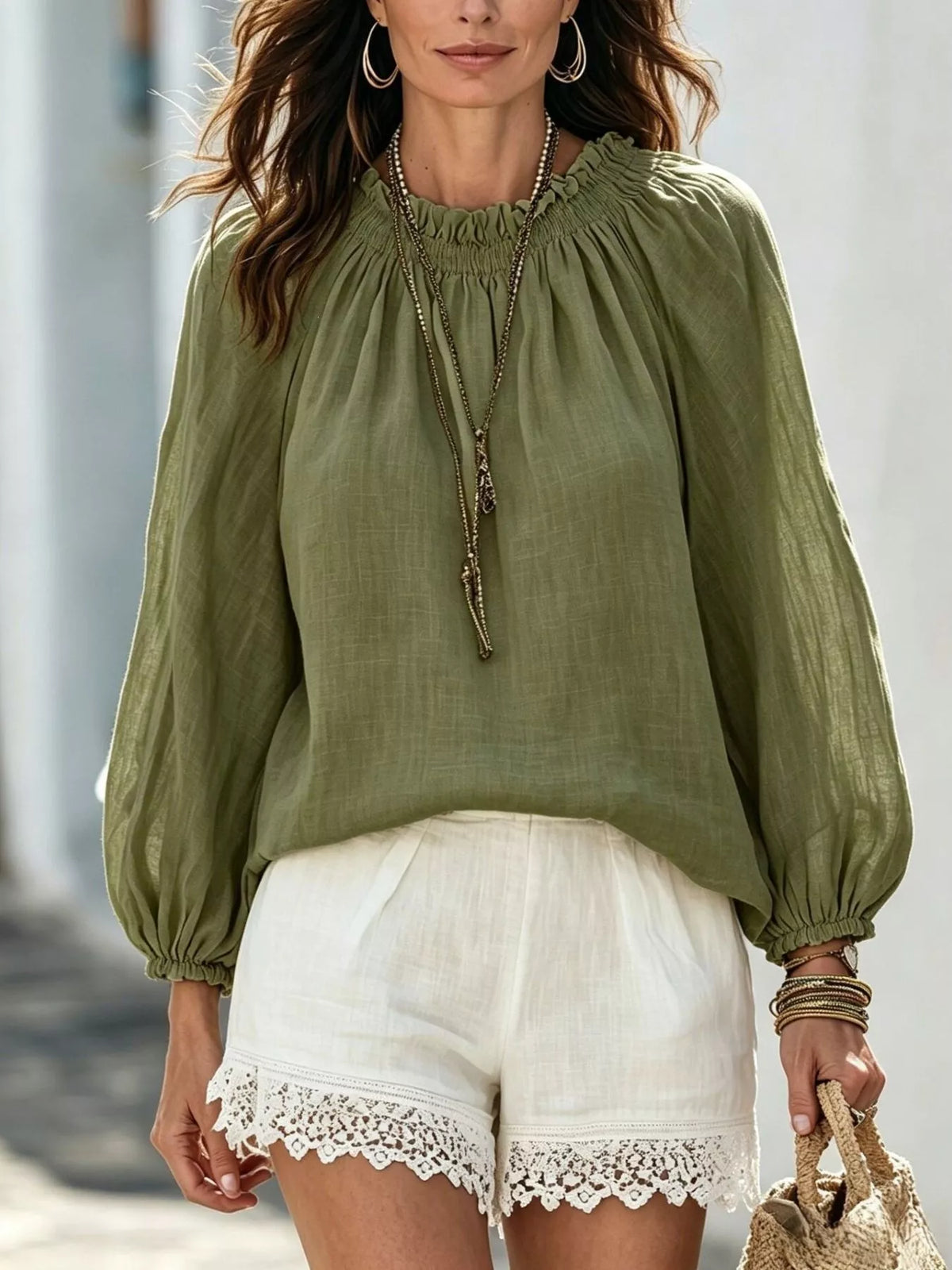 Women’s round neck balloon sleeve blouse by Trendsi featuring a relaxed fit and stylish design, shown in a natural fabric texture.