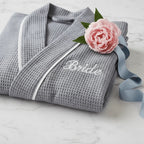 Lotus Linen women's knee-length waffle robe with embroidered details, soft and cozy for comfortable lounging.