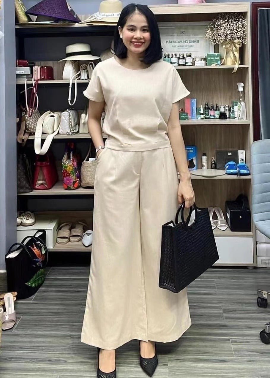 European and American women's linen casual two-piece suit with loose fit and solid color, featuring a stylish top and matching bottom.