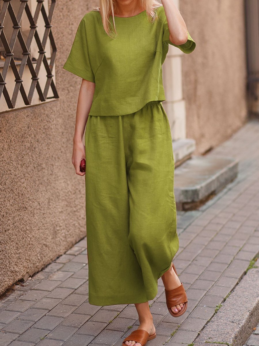 European and American women's linen casual two-piece suit with a loose fit and solid color, featuring a stylish top and matching bottoms.