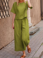 European and American women's linen casual two-piece suit with a loose fit and solid color, featuring a stylish top and matching bottoms.
