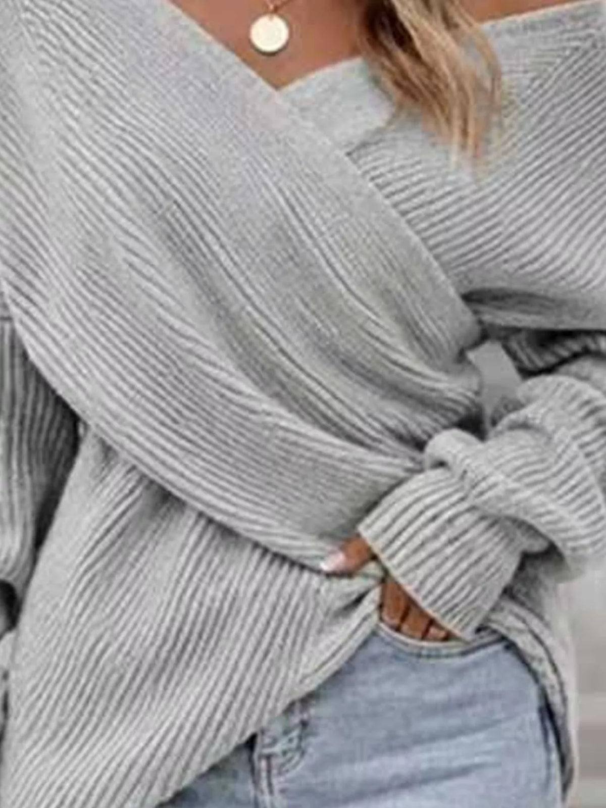 Crisscross ribbed knit long sleeve sweater from Trendsi, featuring a fitted design and textured fabric in a neutral color.