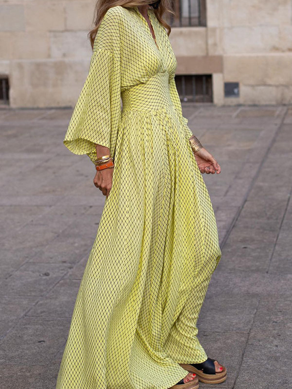 Elegant V-neck maxi dress with flowing sleeves by Trendsi, featuring a flattering fit and stylish design in soft fabric.