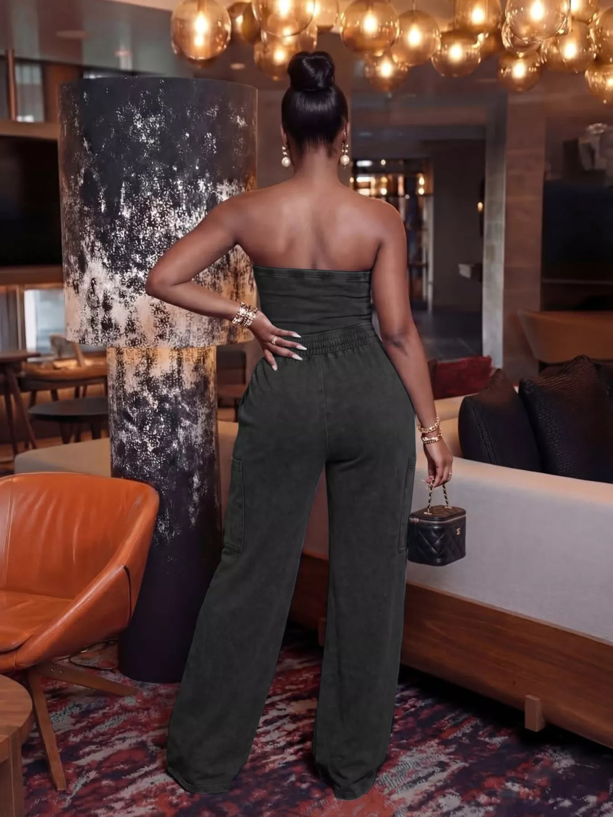 Strapless wide-leg jumpsuit with drawstring waist from Trendsi, shown in black fabric with relaxed fit and stylish design.