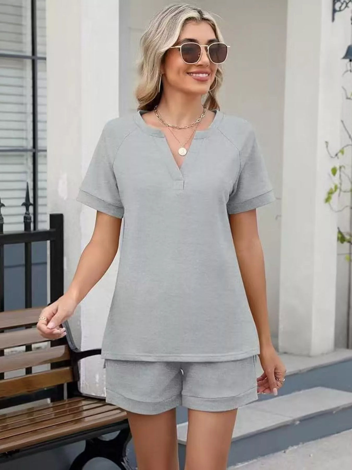 Solid color short sleeve top and matching shorts from Plush Fashion Hub two-piece set, casual summer apparel.